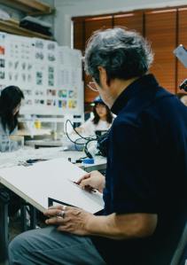 A lively art class in Shinjuku, Tokyo, showcasing creative interactions between students and teacher.